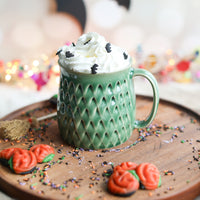 A green dinosaur mug from Glosters.