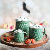 A green dinosaur mug in three sizes from Glosters.