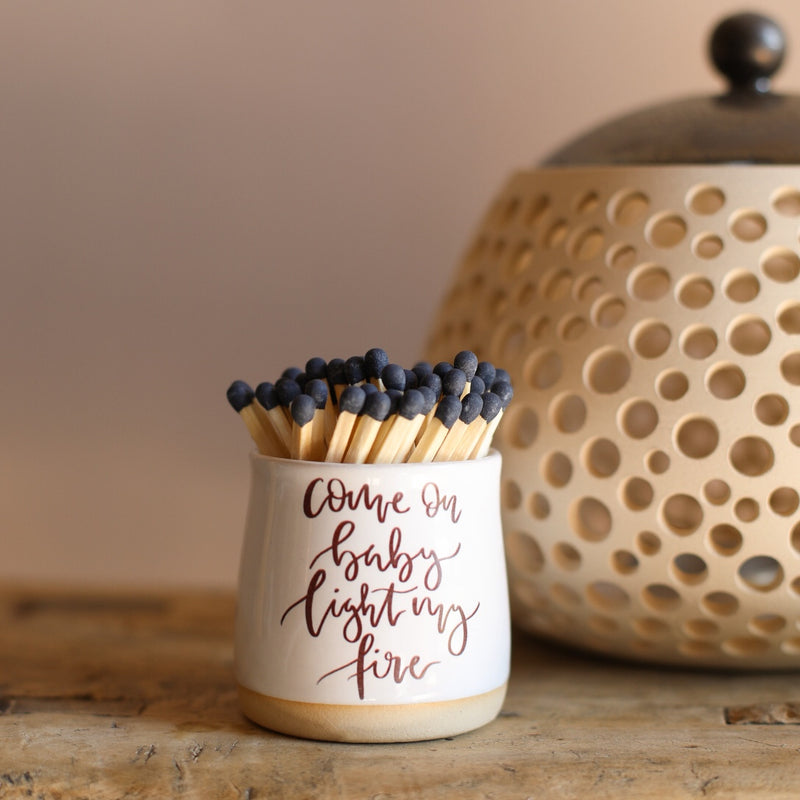 A small ceramic pot filled with matches