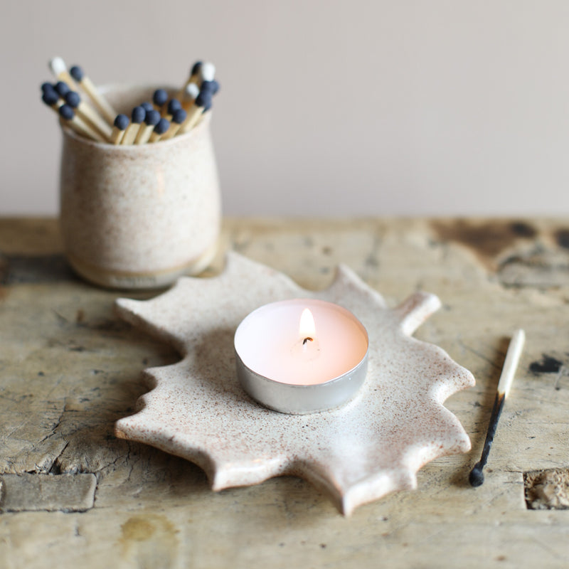 A colourful ceramic dish in the shape of a leaf, made by Glosters